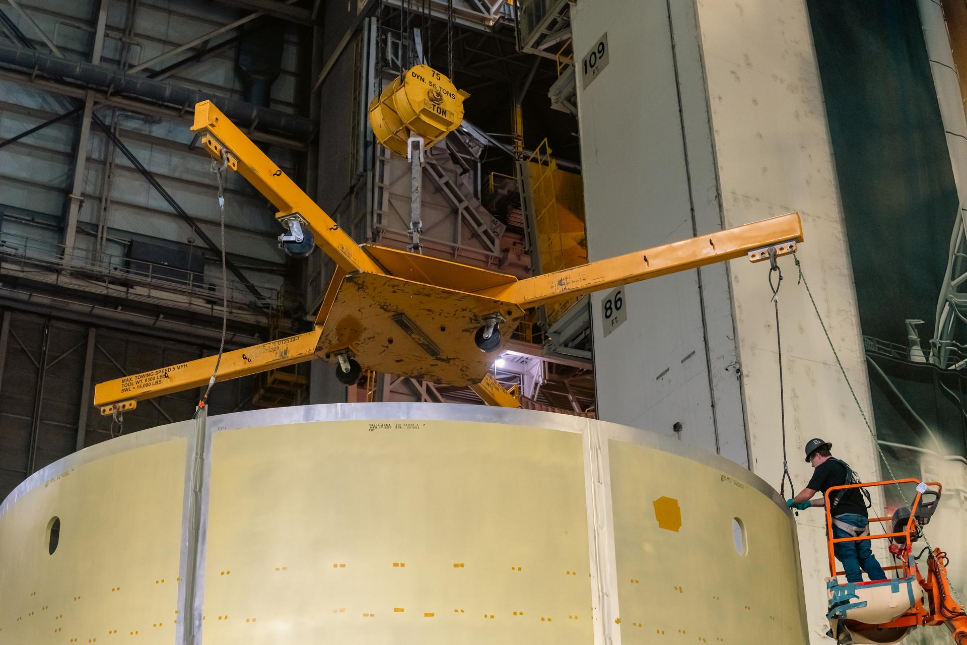 Teams at Michoud Assembly Facility in New Orleans load the engine section barrel into the vertical assembly center on Aug. 5, 2026. The engine section will be used on the SLS (Space Launch System) rocket’s core stage for the agency’s Artemis V mission. On the vertical assembly center tooling, teams will mate the flight hardware to a ring, which will serve as an attachment point for the liquid hydrogen tank later in the production process.    The engine section is one of five major elements that make up the 212-foot-tall SLS rocket stage; and houses various avionic systems, the engine thrust structure, and four RS-25 engines. The core stage produces more than two million pounds of thrust to help launch NASA’s Orion spacecraft, astronauts, and supplies beyond Earth’s orbit and to the lunar surface for Artemis.